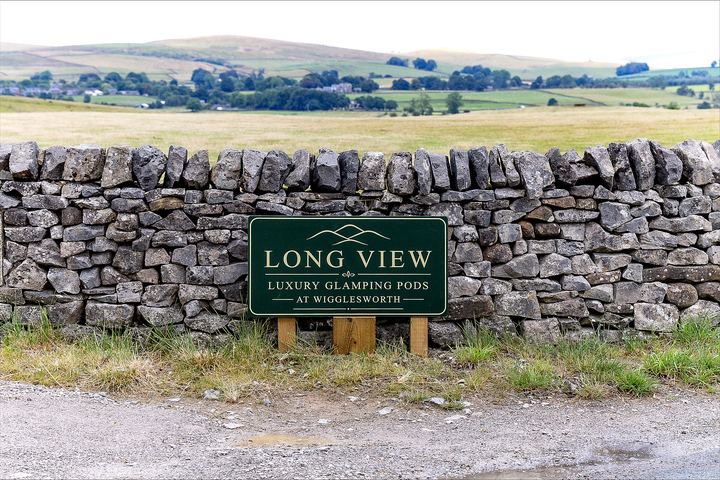 Longview sign beside a dry stone wall